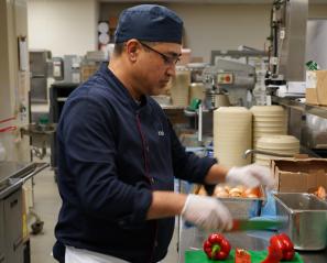 Chef is preparing some food in a kitchen