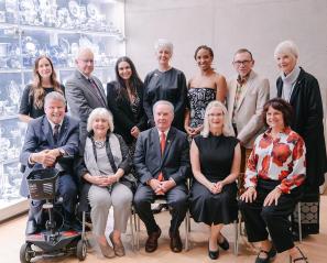 Dr. Peter Rumney (second from left, top row) and Zoe Garzouzi, chair of Holland Bloorview’s Youth Advisory Council (third from left, top row), pose with the 2026 Empowered Kids Ontario Tribute Award winners. Also pictured are EKO leadership and the evening’s host, the Honourable Jim Munson.