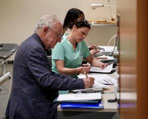 Dr. Peter Rumney reviewing charts with the Brain Injury Rehab team at Holland Bloorview, 2025.