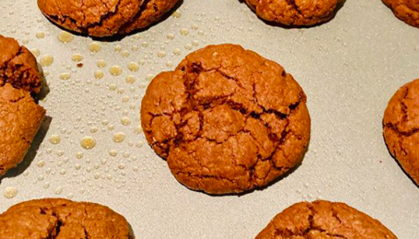 Brown Nutella cookies placed on a baking tray. 