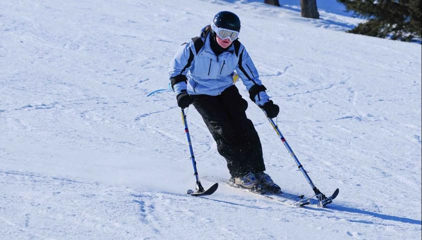 Cynthia skiing down a snow-covered hill. 