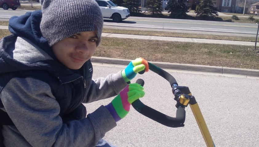 Ollie riding his adaptive bike.