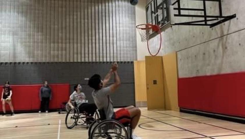 Roshan playing wheelchair basketball.