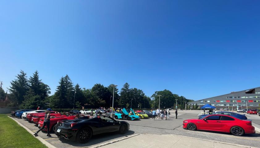 Multiple exotic cars parked in the Holland Bloorview lot.