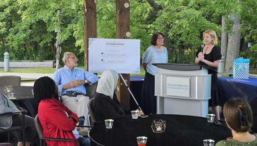 Dr. Madison Links speaking in front of audience