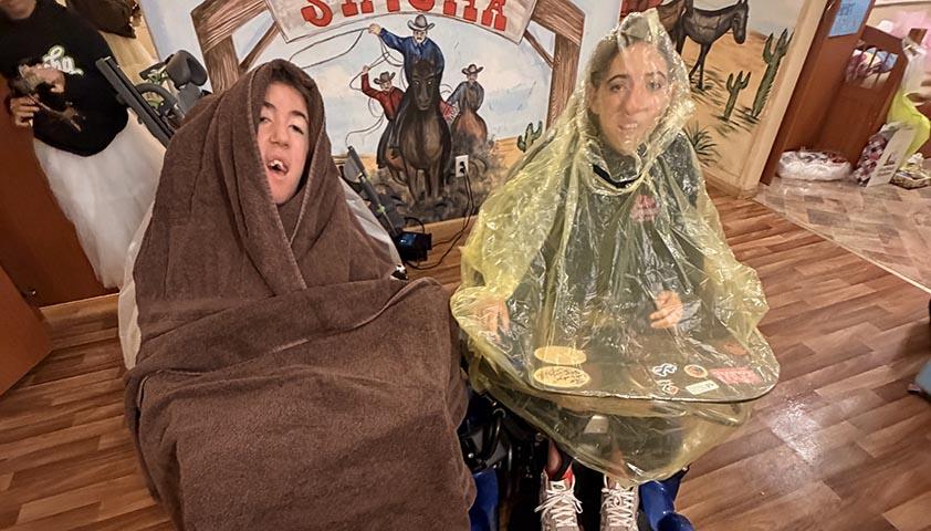 Two teenagers dress up in a camping