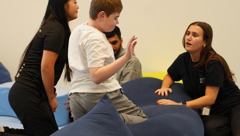 A child and two adults playing a game