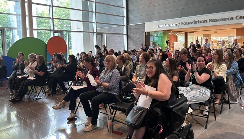 audience in atrium attending an award ceremony