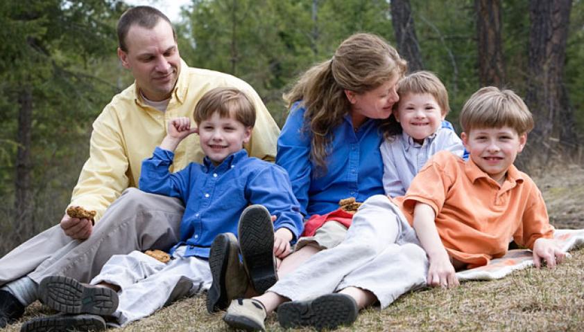 Avery and his family sitting on the grass