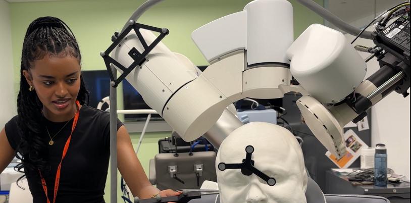 Female student demonstrates the transcranial magnetic stimulation technology