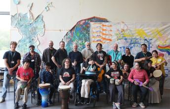 HB Rocks band members pose with volunteers, staff, and members of The Jam music hobbyist group.