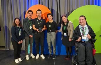 A group of people receiving an award on a stage