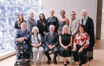 Dr. Peter Rumney (second from left, top row) and Zoe Garzouzi, chair of Holland Bloorview’s Youth Advisory Council (third from left, top row), pose with the 2026 Empowered Kids Ontario Tribute Award winners. Also pictured are EKO leadership and the evening’s host, the Honourable Jim Munson.