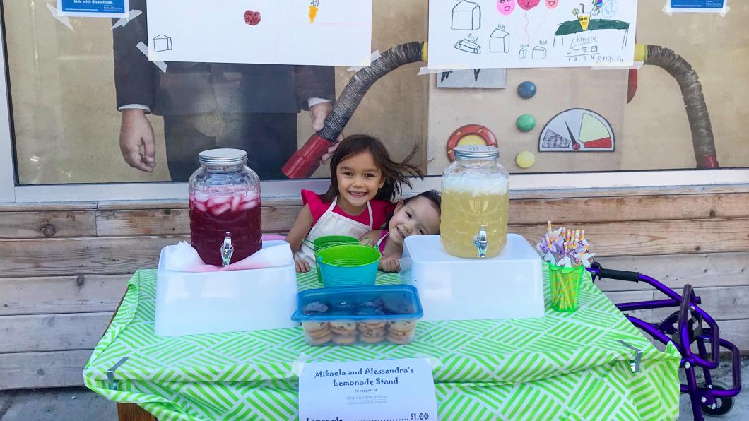 Mikaela and Alessandra selling lemonade.