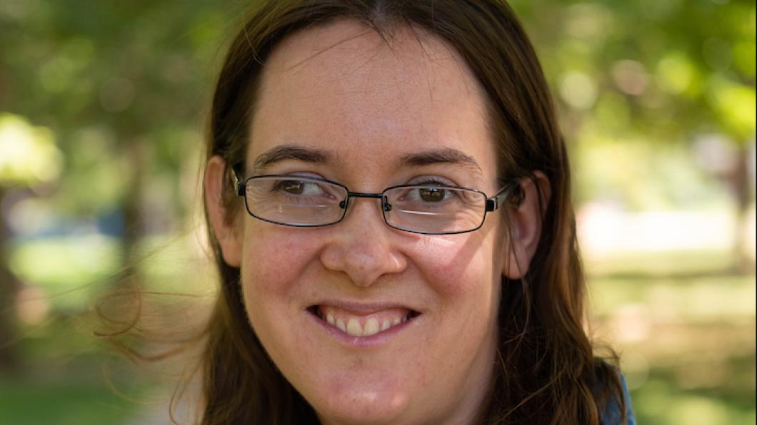 Young woman with glasses smiles