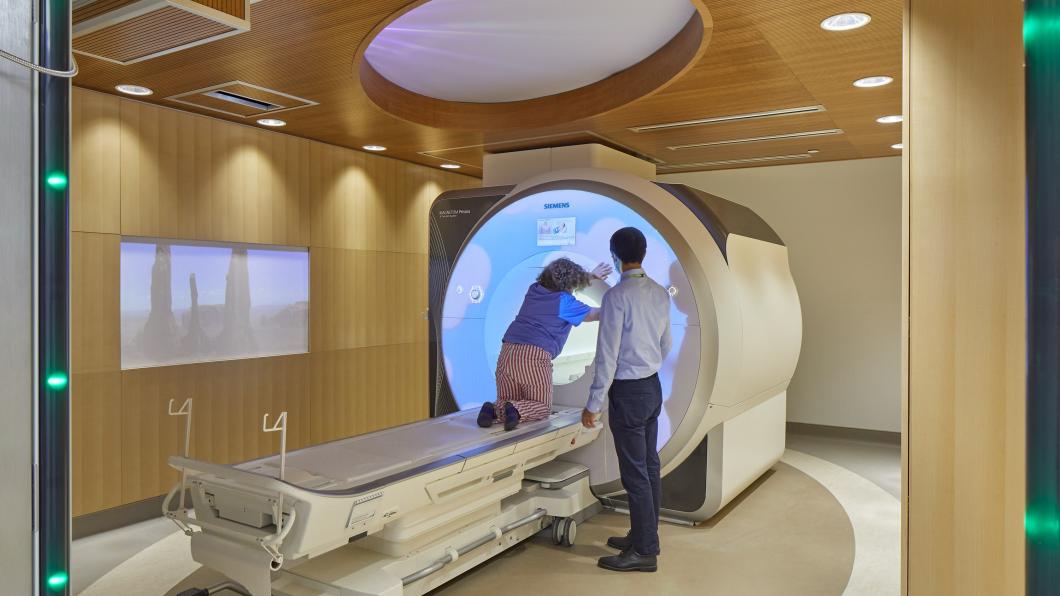 Child entering MRI Machine and doctor standing beside them 