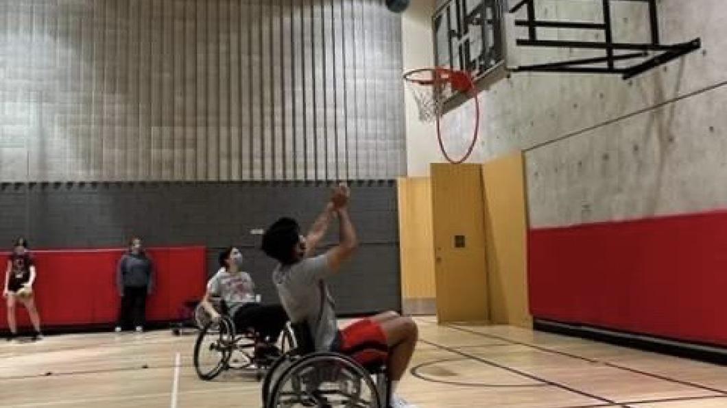 Roshan playing wheelchair basketball