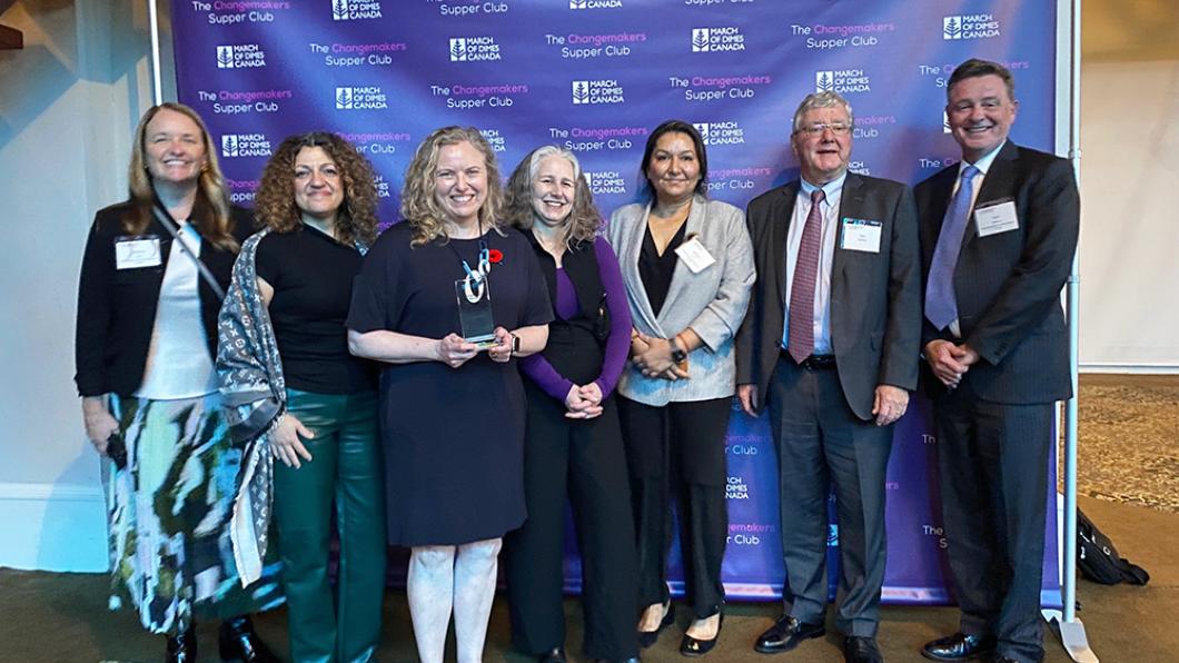 A group of people in a awards giving celebration event