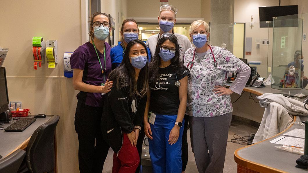 Some hospital staffs having a group photo in a hospital setting