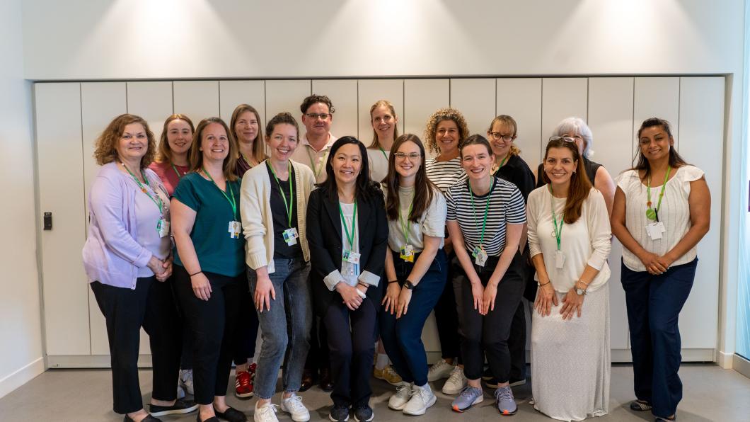 Group photo of get up and go staff standing in front of a white wall.