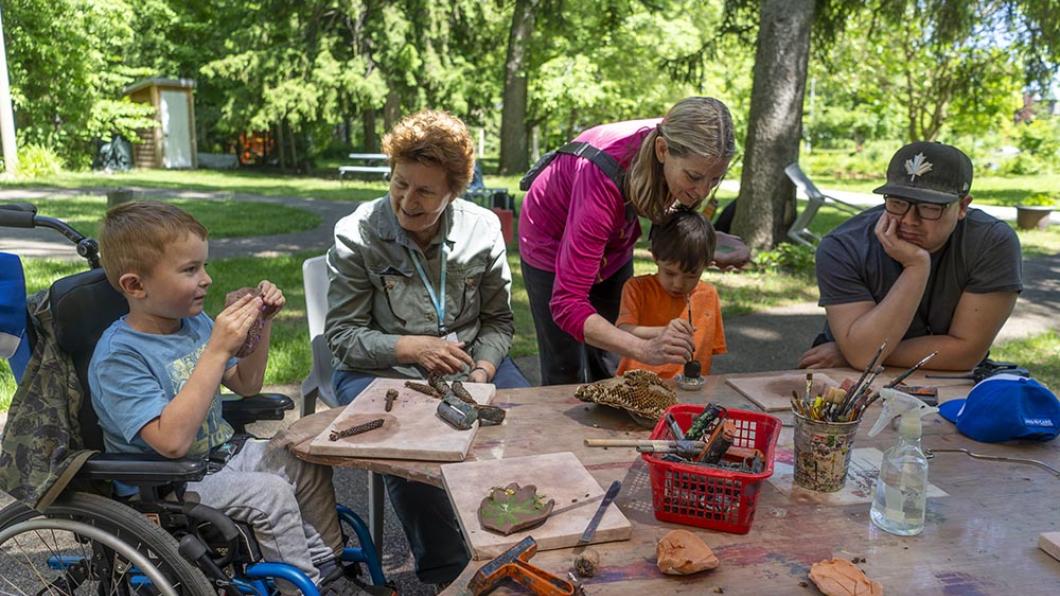 Group photo of people doing art in spiral garden. 