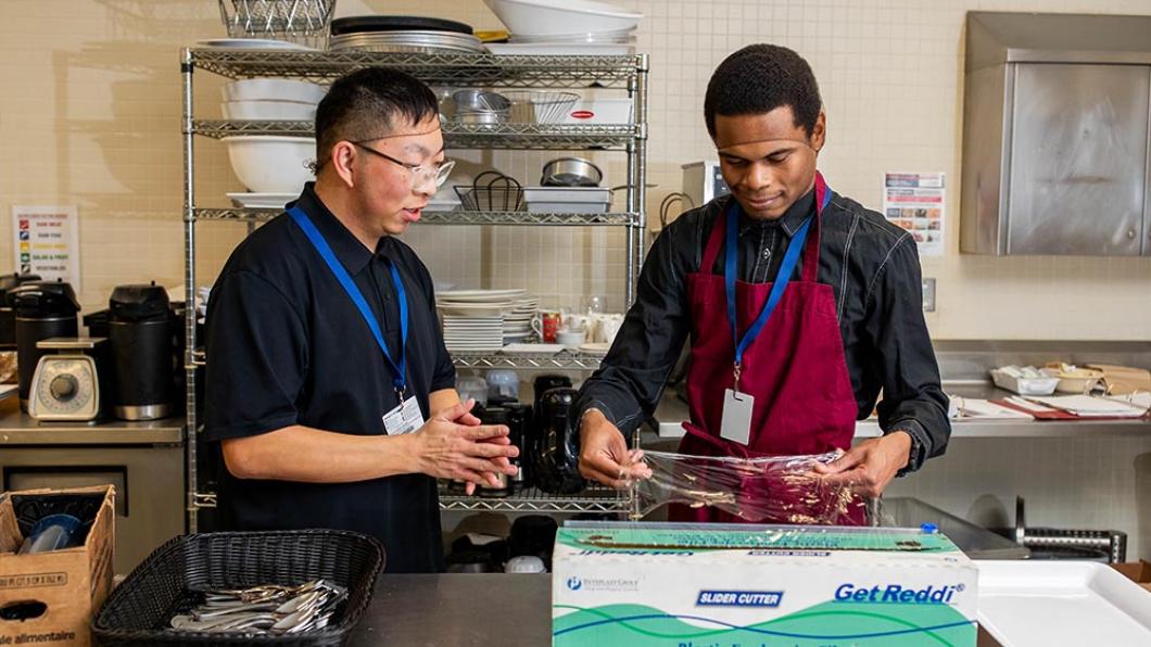 Two people working in a kitchen