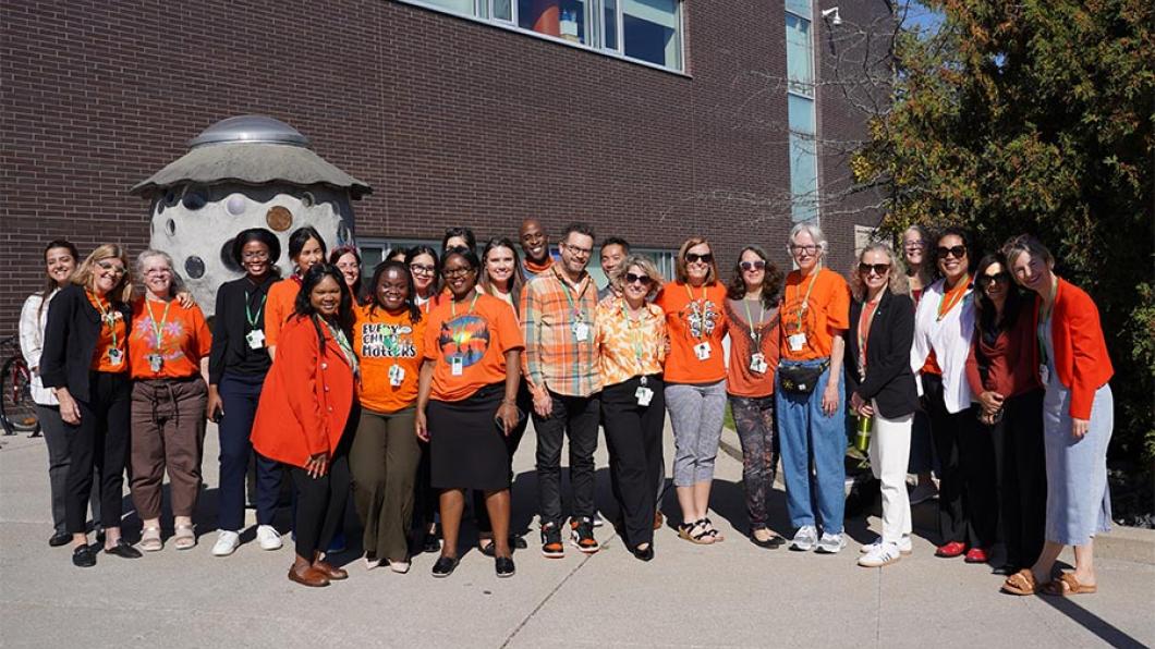 Group of people in an outdoor setting wearing orange