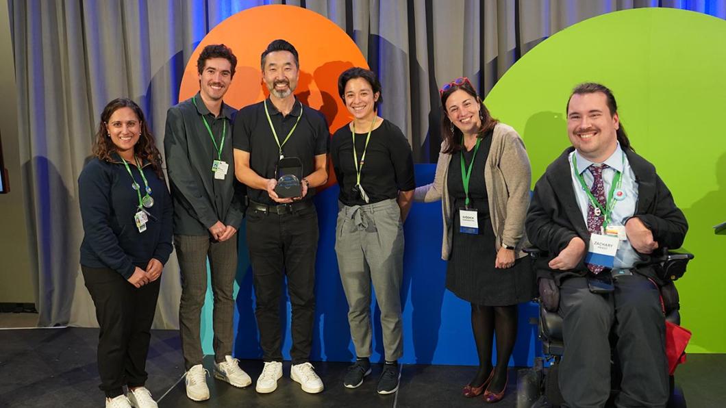 A group of people receiving an award on a stage