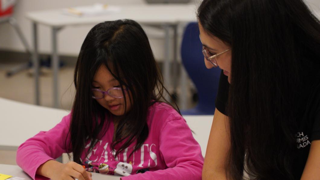 A child and an adult playing Bingo at a table