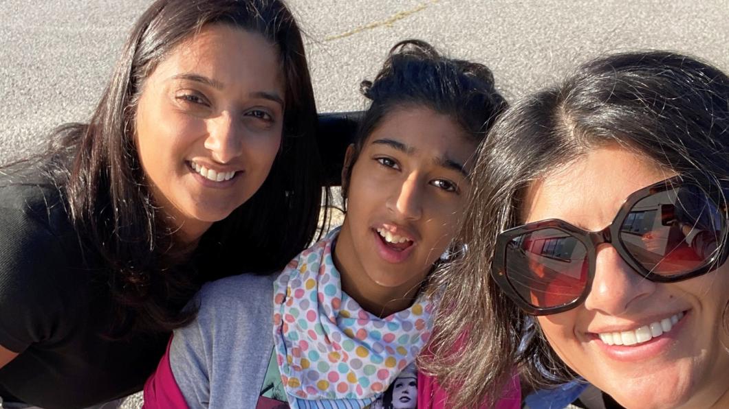 Teen girl and two women smile