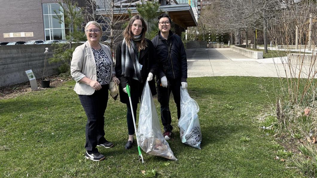 Some people picking up garbage from the glass.