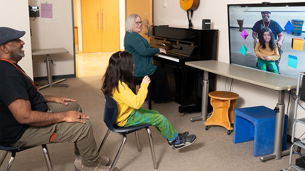 A child plays music using a virtual music instrument