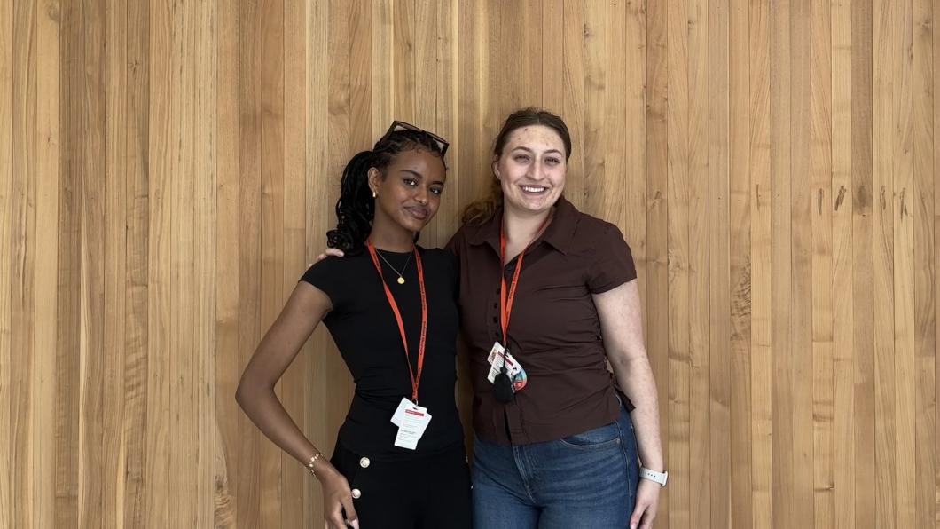 Two female students standing and posing for a photo