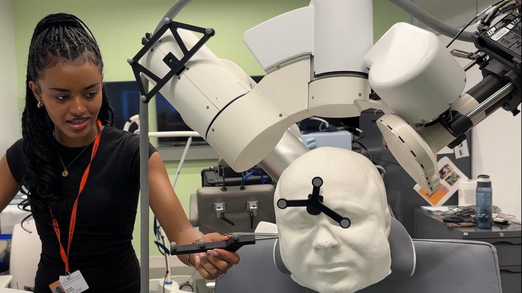 Female student demonstrates the transcranial magnetic stimulation technology