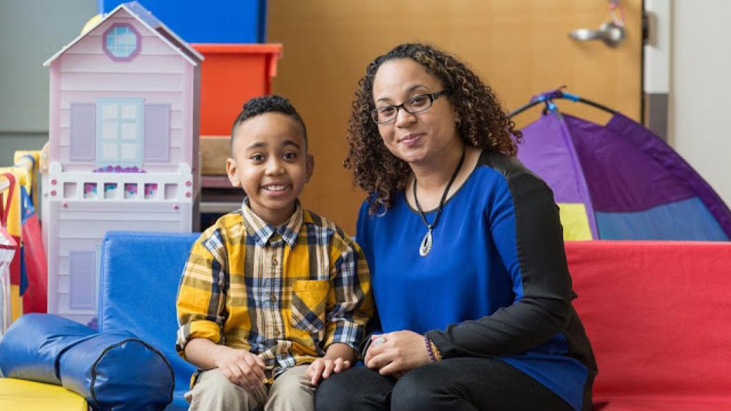 A woman and a boy sitting on a couch