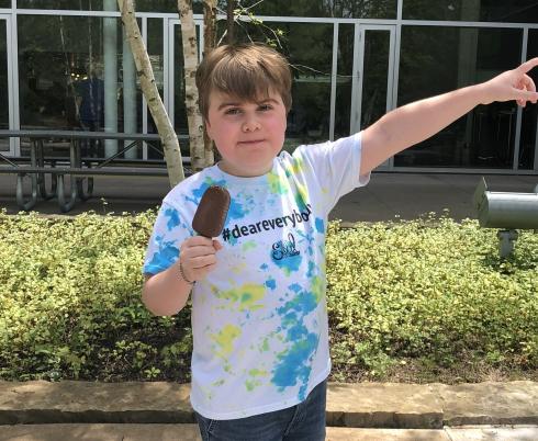 Emery in a #DearEverybody shirt with a popsicle