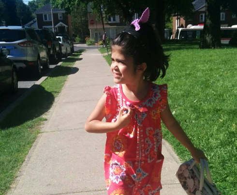 Lilly wearing a pink dress enjoying the warm weather