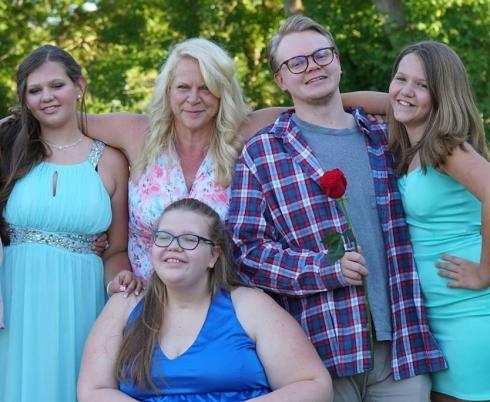 Christine and her kids smiling at the camera.