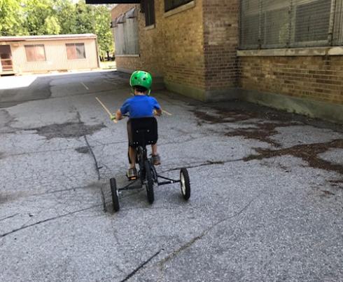 Child pedalling on his bike.