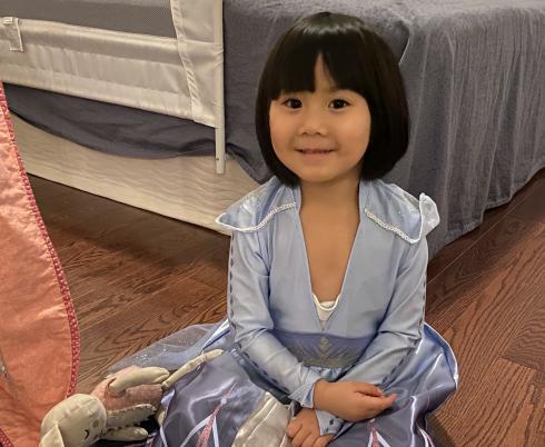 Mimi smiling in her Elsa dress. 