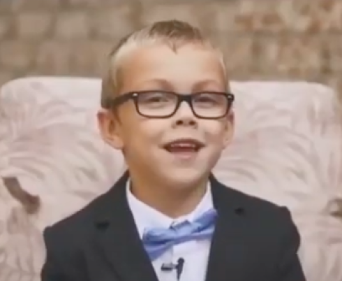 Alex smiling at the camera with his blue bowtie. 
