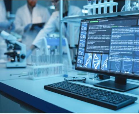 Image of computer with researchers in the background