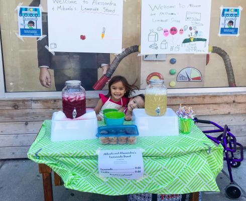 Mikaela and Alessandra selling lemonade.