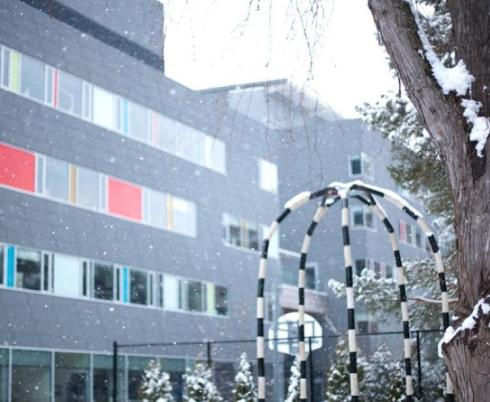 Spiral Garden is shown with Holland Bloorview in the background and light snow falling