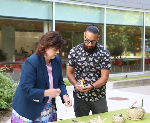 Deborah Richardson, Ontario’s Deputy Minister of Health and Conrad Prince, lead of Indigenous health strategy, Toronto Academic Health Science Network, preparing the smudging ceremony during the opening event.