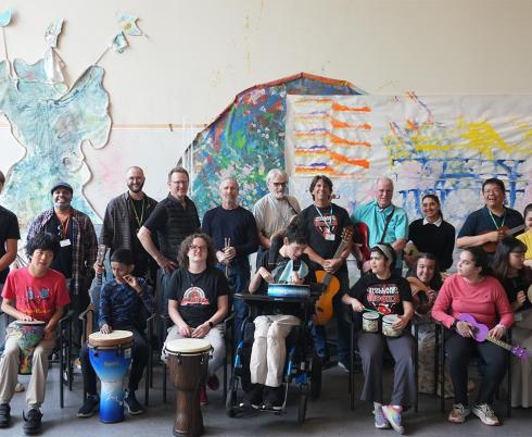 HB Rocks band members pose with volunteers, staff, and members of The Jam music hobbyist group.