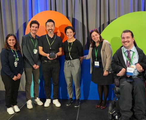 A group of people receiving an award on a stage