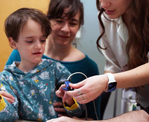 A child is having a test by clinical staff