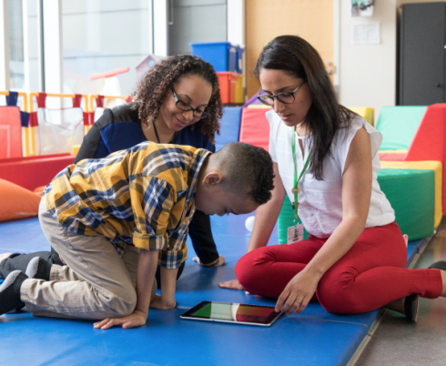 Two adults playing with a kid