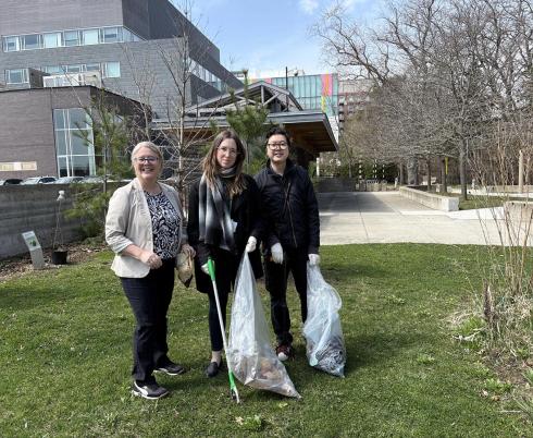 Some people picking up garbage from the glass.